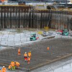 a group of construction workers standing around a construction site