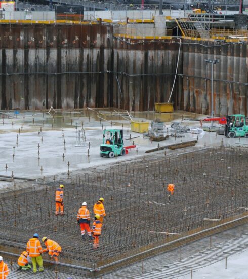 a group of construction workers standing around a construction site